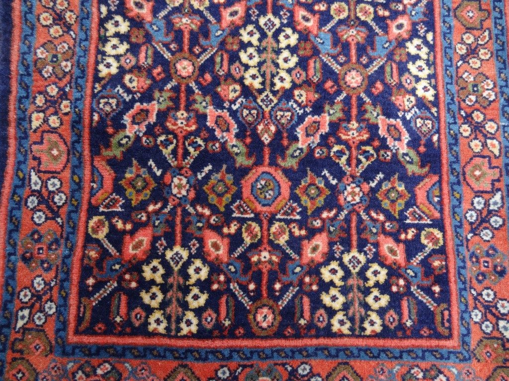 Small semi antique dark blue and pink rug from Persia