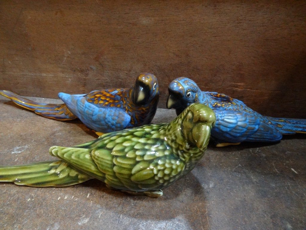 Green and blue ceramic parrots