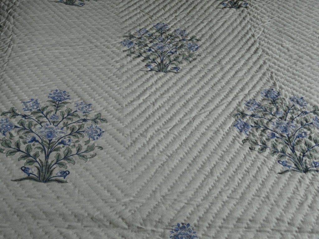 Cream and blue quilted bedspread